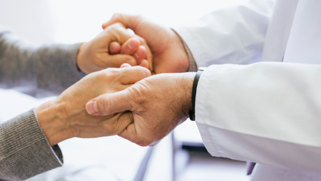 Doctor holding a patients hands