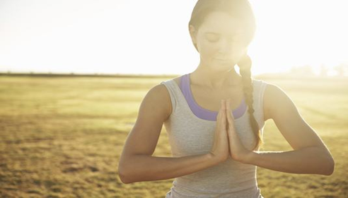 Woman meditating at the beach