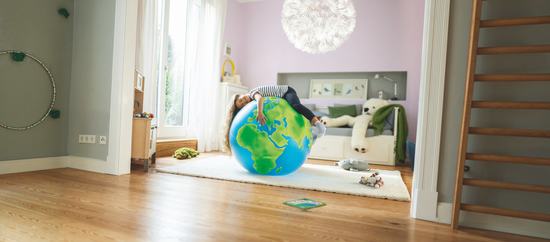 Child laying on an Earth shaped ball