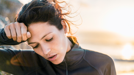 Woman holding her head in pain