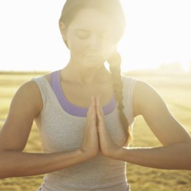 Woman meditating at the beach