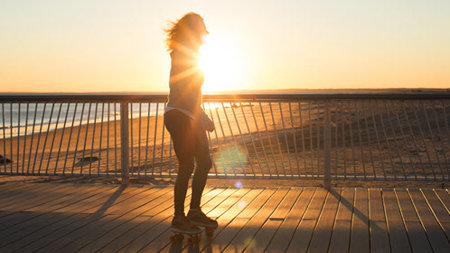 Woman rollerblading during sunrise