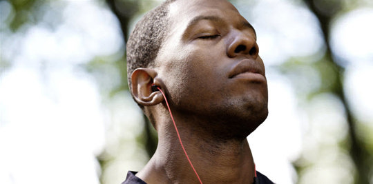 Man with headphones in a forest