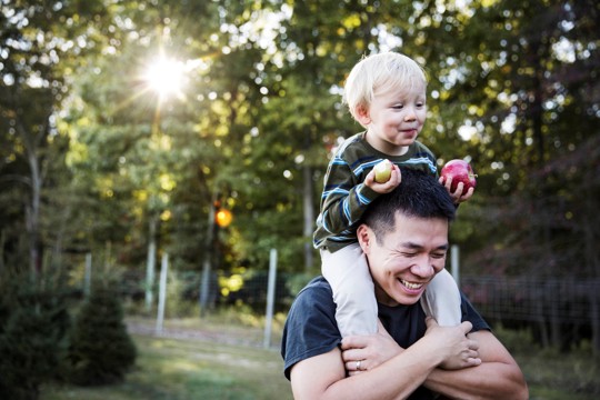 Father with son on his shoulders.
