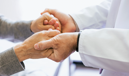 Doctor holding a patients hands