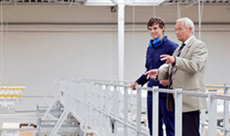 old man talking to his employee about products