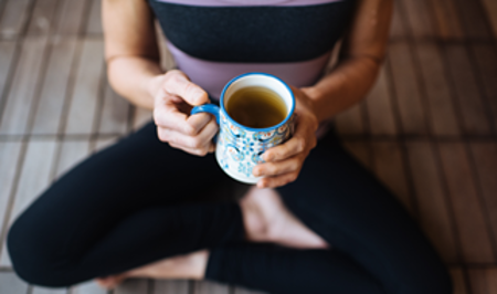 Woman sitting and holding a coffee mug