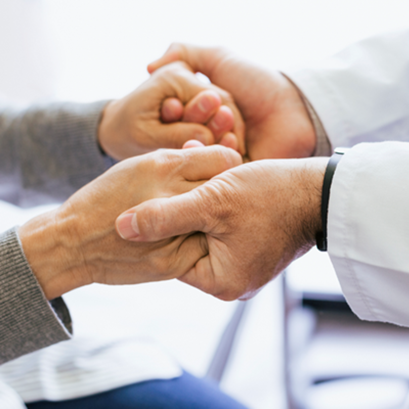 Doctor holding a patients hands