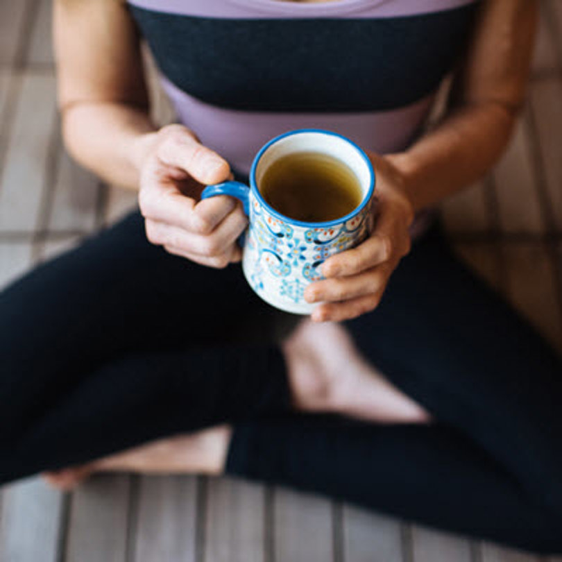 Woman sitting and holding a coffee mug