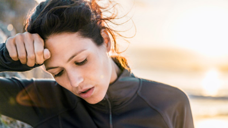 Woman holding her head in pain