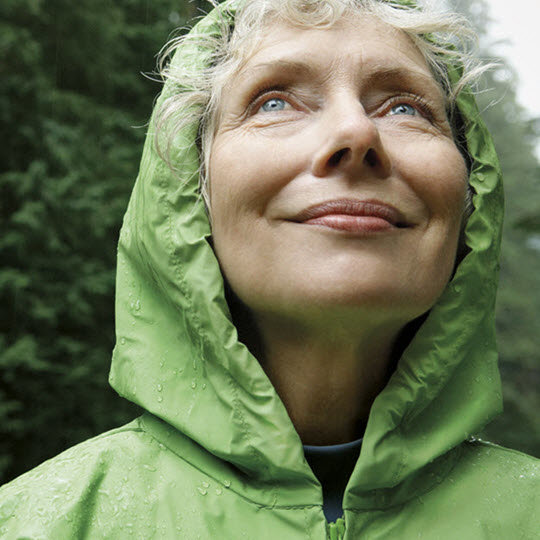 Woman in a raincoat smiling