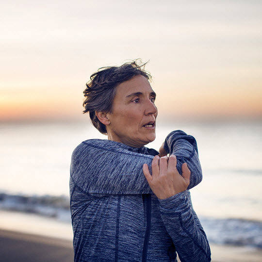 Woman stretching at the beach